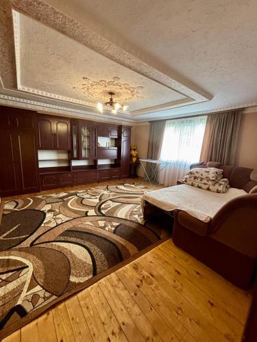 a living room with a large carpet and a couch at ЮрДар in Iltsi