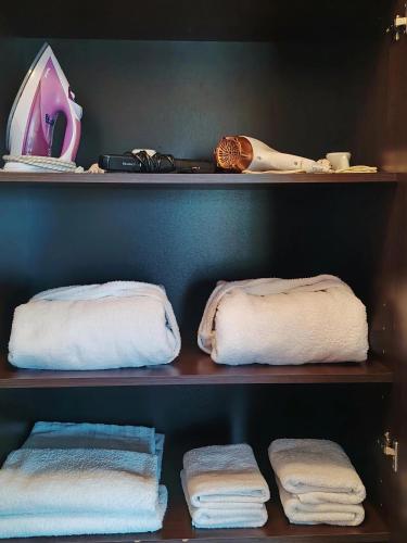 two shelves with towels on them in a closet at Adrian Home City in Ploieşti