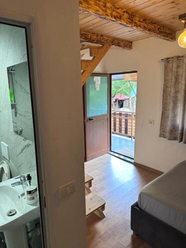 a bathroom with a sink and a mirror at Shpia e Mikut Guesthouse in Theth