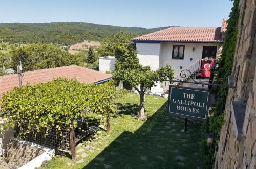 a sign in front of a building with a house at The Gallipoli Houses in Eceabat
