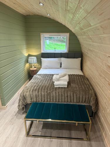 a bed in a small room with a window at Pennygael in Lanark