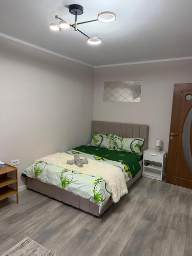 a bedroom with a bed and a ceiling fan at Sofia Apartment in Galaţi