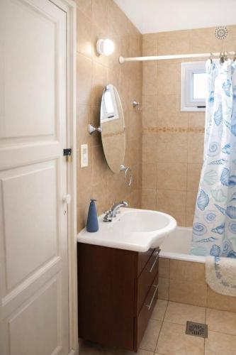a bathroom with a sink and a shower curtain at Arístides Azul in Mendoza