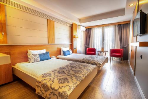 a hotel room with two beds and a television at May park HOTEL in İzmir