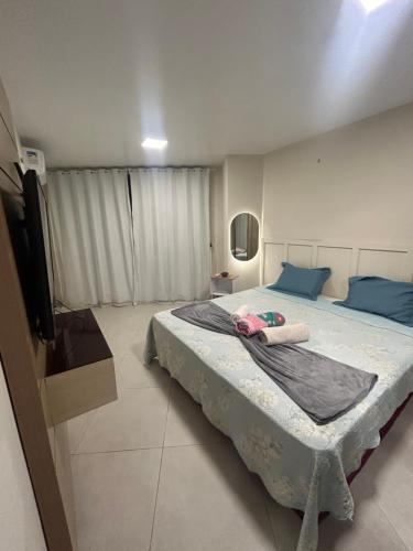 a bedroom with a large bed with blue pillows at Vista mar nascente in São Luís