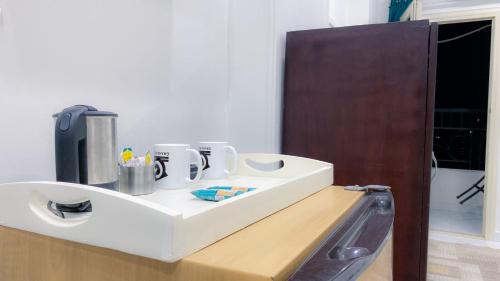 a bathroom with a white sink and a mirror at Grand Hotel Qena in Qinā