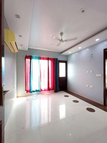 a living room with a large white room with windows at The Olive County in Thirumurugan Poondi