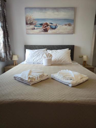 a bed with two towels on top of it at Maitos Apartments in Galanádhon