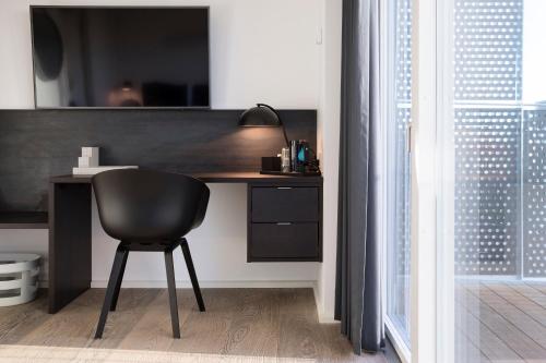 a black desk with a black chair in a room at CPH Studio Hotel in Copenhagen