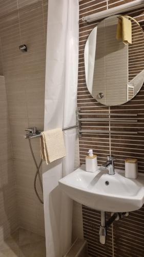 a bathroom with a sink and a mirror at Lukanov Apartments - Lake view in Ohrid
