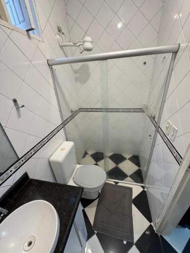a bathroom with a toilet and a sink at Flat Jubarte Praia do Francês in Marechal Deodoro