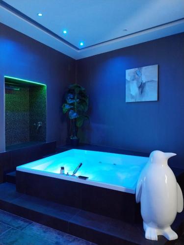 a large bath tub in a blue room with a vase at Relais Viesti B&B in Vieste