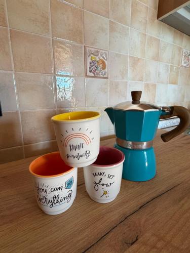 a group of four coffee cups sitting on a counter at Da Elio in Montacuto