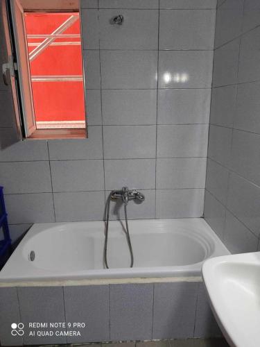 a bath tub with a faucet in a bathroom at Spacious-Central Apartment in Himare