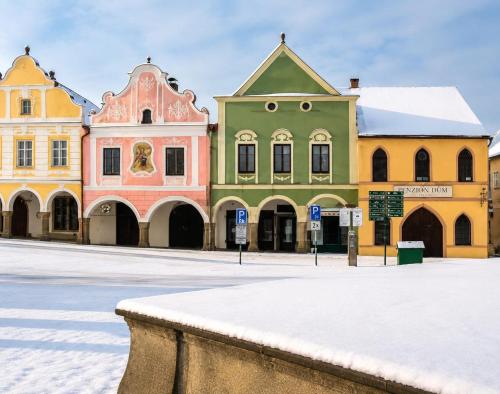 a group of buildings on a snow covered street at MiMo penzion in Telč