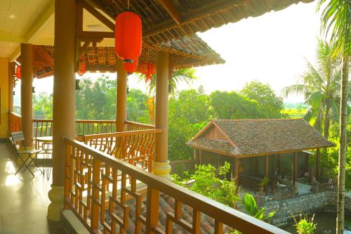 a balcony of a house with a view of a garden at Y Van Cac Homestay Ninh Binh Art Heritage Rice Field in Ninh Binh