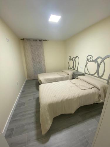 a room with three beds in a room at Apartamento Chicuelo in Ariza