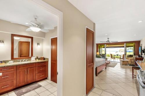 a bathroom with a sink and a room with a bedroom at Maui Eldorado Condo J221 in Kaanapali