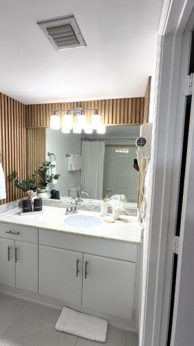 a bathroom with a sink and a large mirror at Luxury executive Studio in Brickell in Miami