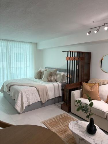 a bedroom with a large bed and a chair at Luxury executive Studio in Brickell in Miami