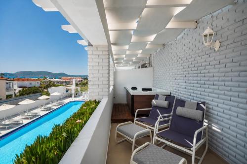 a balcony with chairs and a swimming pool at Meandros Boutique & Spa Hotel - Adults Only in Kalamaki