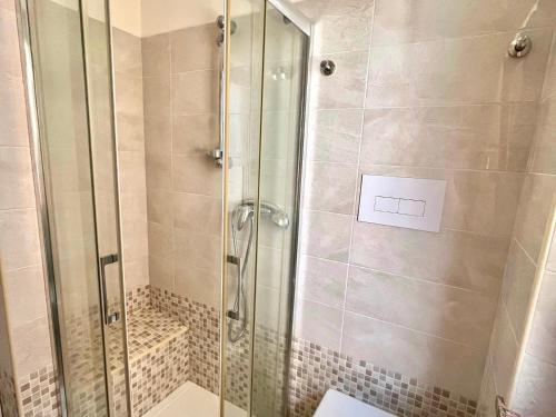 a shower with a glass door in a bathroom at Casetta IV Vico- Chianalea in Scilla