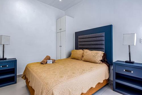 a bedroom with a bed with two blue night stands at Dog-Friendly Suite with Kitchenette, Heated Outdoor Pool, Hot Tub, Terrace, AC in Rosarito