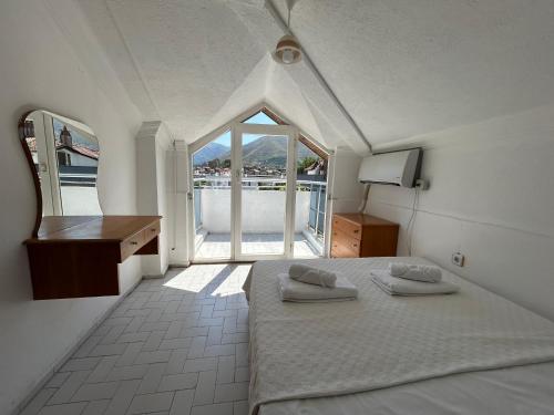 a bedroom with a bed and a desk and a window at Double Comfort Marmaris in Marmaris