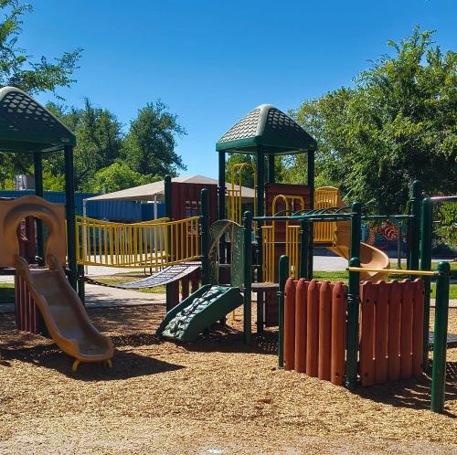 a playground with a slide in a park at IreneHouse Victorian INN in Sacramento