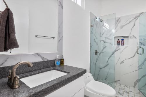 a bathroom with a sink and a shower at Dog-friendly home 3 rows to beach with rooftop deck, pool, & kitchen in Rosarito