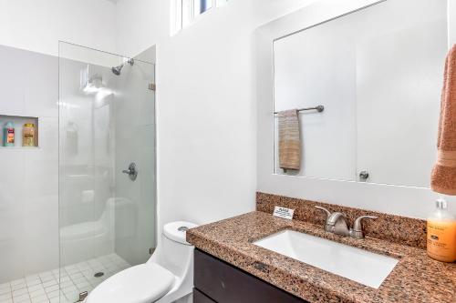 a bathroom with a sink and a toilet and a shower at Dog-Friendly Ocean-View Home with Heated Outdoor Pool, Hot Tub, Streaming, Patio in Rosarito