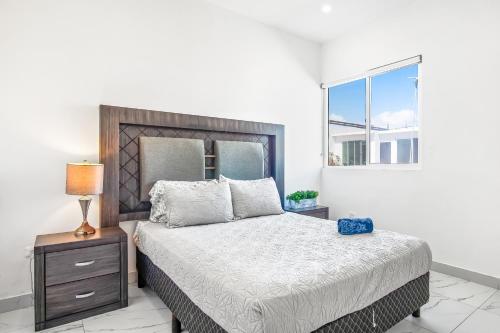 a bedroom with a large bed and a window at Dog-Friendly Home with Heated Pool, Hot Tub, Partial Ocean Views & Balcony in Rosarito