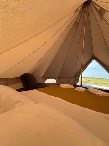 a large tent with a bed and a window at COMPORTA SIDE - Tents in Setúbal