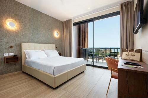 a hotel room with a bed and a balcony at Hotel Gallia & Resort in Lido di Jesolo