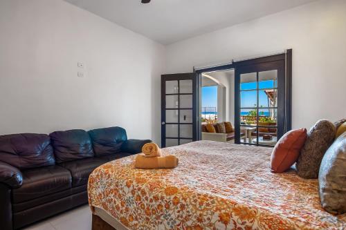 a living room with a couch and a bed at Airy, Beach-View Dog-Friendly Villa with Patio, Outdoor Pool, Streaming, AC in Rosarito