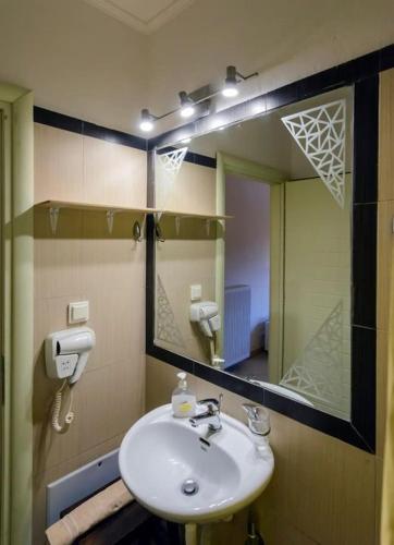 a bathroom with a sink and a mirror at Ktima Anastasia Olive Grove Nafplio in Nafplio
