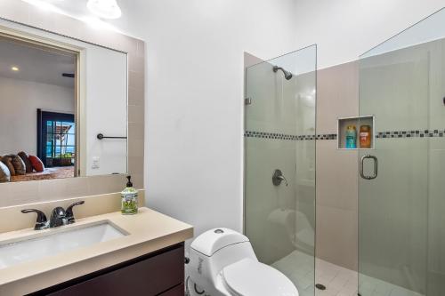 a bathroom with a shower and a toilet and a sink at Airy, Beach-View Dog-Friendly Villa with Patio, Outdoor Pool, Streaming, AC in Rosarito