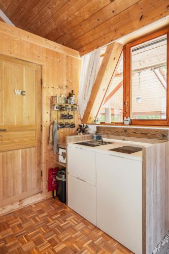 a kitchen with a white counter and a window at ECO-CHALET Bel Oiseau - Saint-Ursanne in Saint-Ursanne