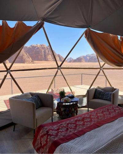 a room with a view of the desert from a yurt at Ain Rum Luxury Camp in Wadi Rum