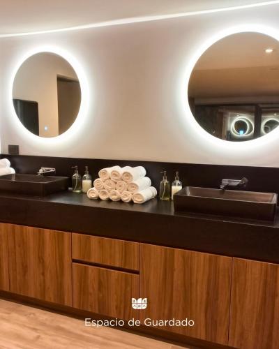 a bathroom with a sink and a mirror at Hosteria & Spa Las Walkirias in San Martín de los Andes