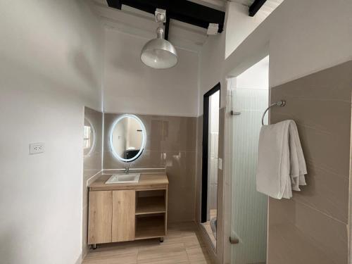 a bathroom with a sink and a mirror at Hotel Cerro Bravo in Fredonia