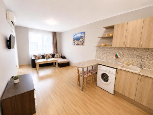 a kitchen and living room with a washing machine at Sunny Day 3 - Pool and Chill in Sunny Beach