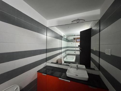 a bathroom with a sink and a mirror at Raintree Villa in Vythiri