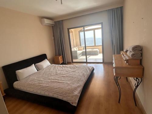 a bedroom with a bed and a dresser and a table at Horizon 3 Villa in Amman