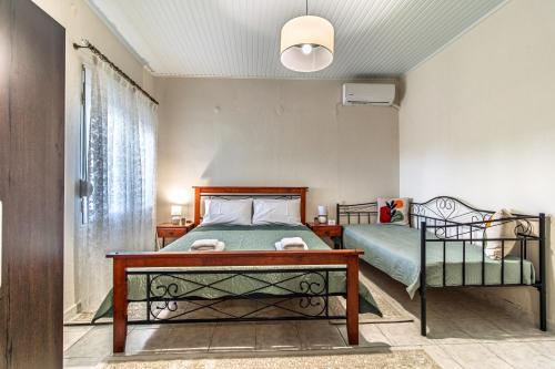 a bedroom with a bed and a table at 4 seasons home Ofrinio in Ofrínion