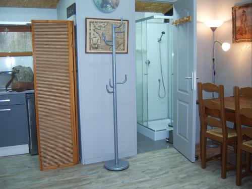 a bathroom with a shower and a table and a glass door at Chalet de campagne LAJA only 5 min from autoroute A75 in Léotoing