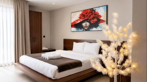 a bedroom with a large bed and a christmas tree at Hotel & Restaurant HAREA in Suharekë