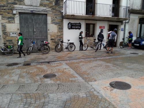 
a street scene with people walking and bicycles at Albergue San Anton in Melide

