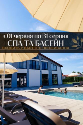 a sign in a swimming pool in front of a building at Підгорецький маєток - готель in Pidhirtsi