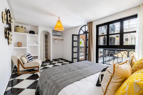 a bedroom with a bed and a checkered floor at Riad Kamil 4Suites - Private Pool - Rooftop Lounge in Marrakesh